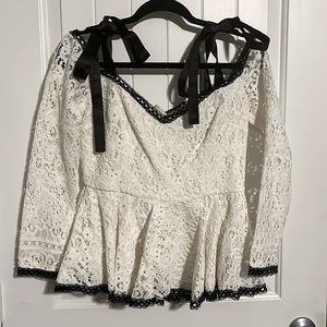 Alexis White lace with black trim peplum top with silk bow shoulder detail
